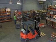 Inside the BISI Fasteners warehouse: stocked shelving and a forklift
